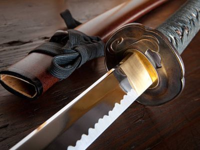 Real japanese samurai sword and sheath on wooden board